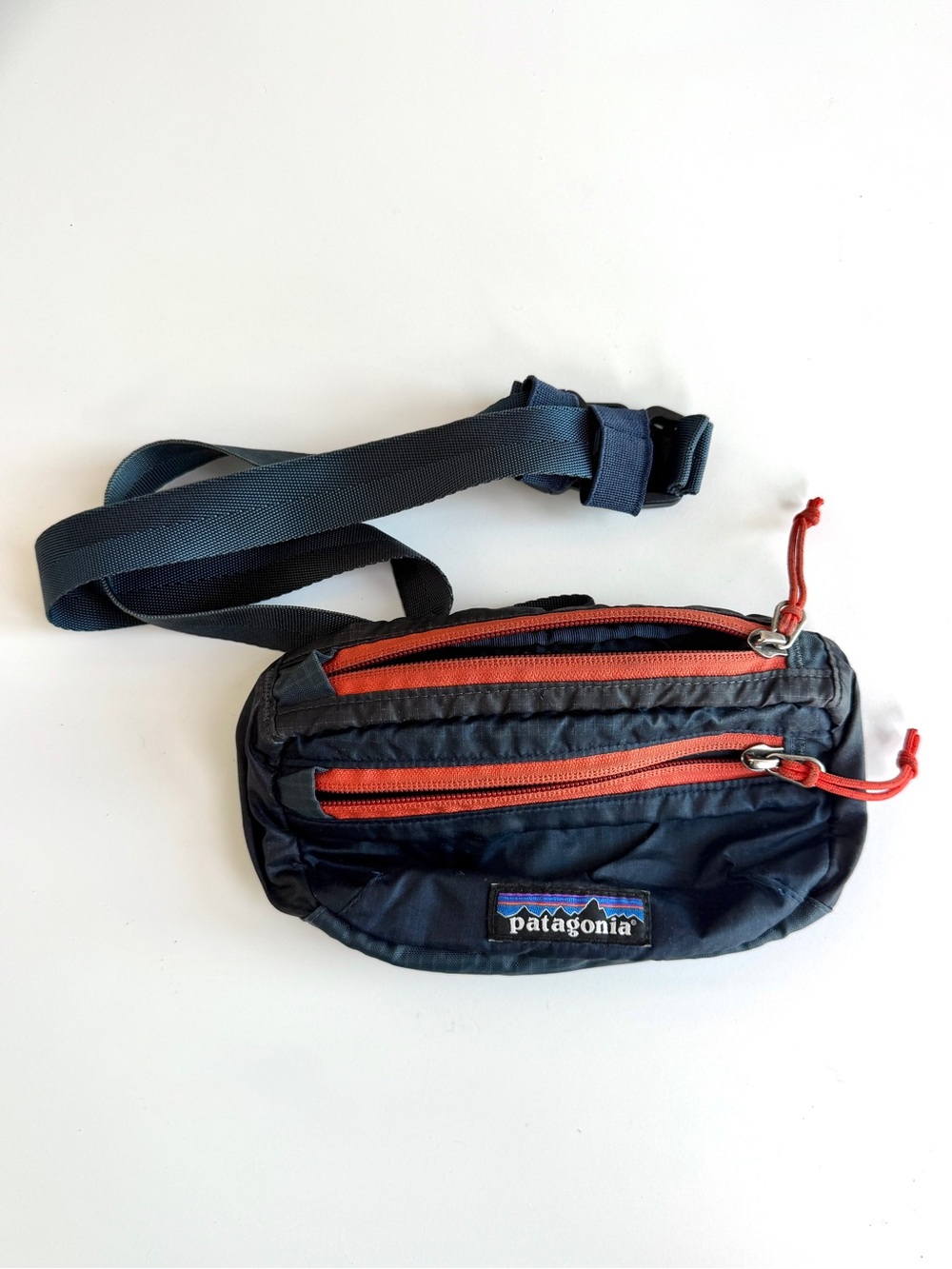 Vintage Patagonia navy belt bag with orange zippers
